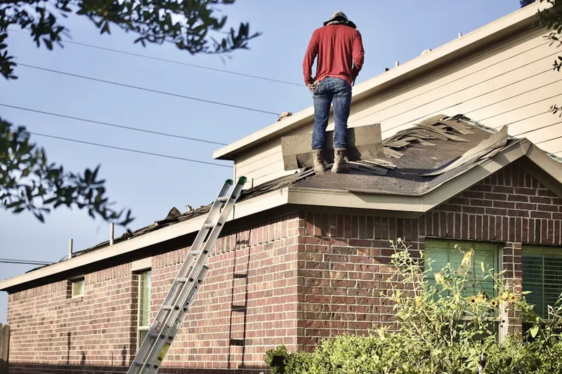 Professional roofer working on a residential roof in North DeKalb